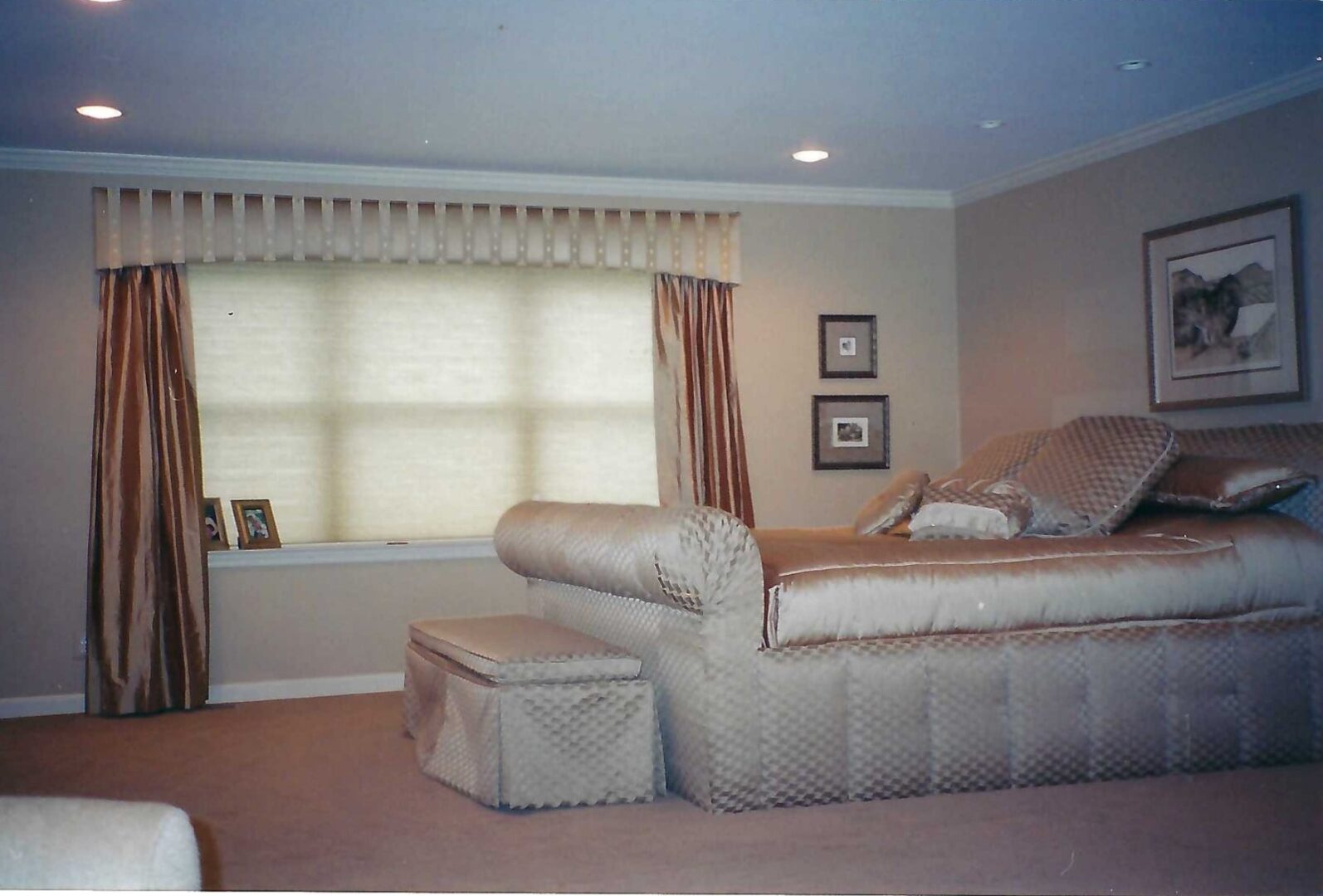 A bedroom with a large bed and a window.